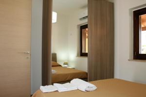 Postel nebo postele na pokoji v ubytování Portoada Park Villas