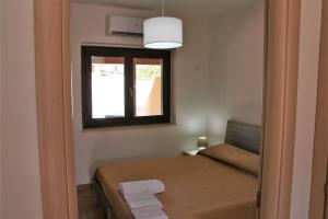 Postel nebo postele na pokoji v ubytování Portoada Park Villas