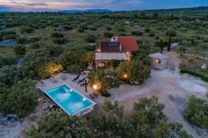 an aerial view of a house with a swimming pool at Holiday Home Kuća Sunca in Sutivan