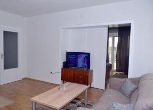 a living room with a couch and a tv at MS Apartment in Ohrid