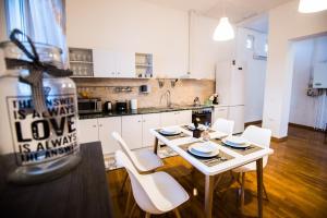 a kitchen with a table and chairs in a kitchen at Writer s street residence in Arad