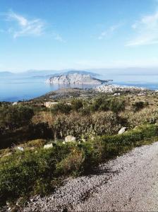 a view of the ocean from a rocky road at Holiday Home in Sfendouri, Aegina in Sfendoúrion +3 photos
