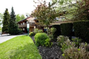 a house with a garden in front of it at Campanile Maubeuge in Maubeuge