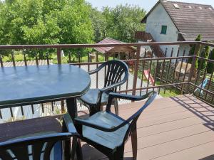 a blue table and chairs sitting on a deck at Judit's Guest House in Fonyód