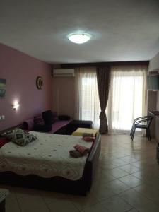 a bedroom with two beds and a living room at Petrino in Sarti