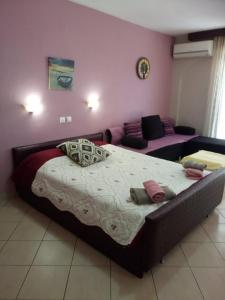 a bedroom with a large bed and a couch at Petrino in Sarti