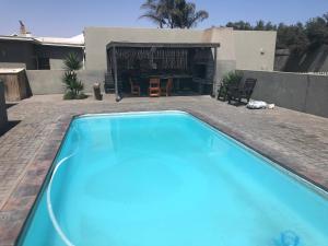 ein Swimmingpool vor einem Haus in der Unterkunft Anas Inn in Walvis Bay