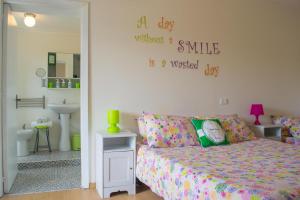 a bedroom with a bed and a wall with words on it at Benvenuti Nel Sud in Sessa Cilento