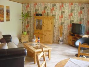 a living room with a couch and a coffee table at Haus am Wald in Hillscheid