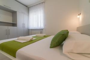 a bedroom with a large white bed with green sheets and pillows at VILLA SOFIJA in Zaton +118 photos