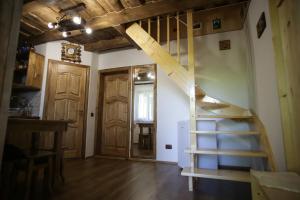 a room with a wooden staircase and a door at Еко Дім з СОЛОМИ in Solochin
