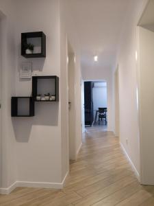 a hallway with white walls and a wooden floor at Apartment Gervais Rijeka in Rijeka