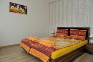 a bedroom with a large bed with blankets and pillows at The House of Petar Levski in Berkovitsa
