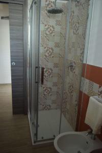 a bathroom with a shower and a sink at Acqua Chiara Appartamenti in San Vito lo Capo