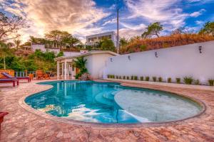 a swimming pool in the backyard of a house at Casa Soma in San Juan del Sur
