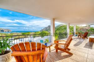 a balcony with chairs and a view of the ocean at Casa Soma in San Juan del Sur