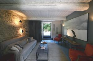 a living room with a couch and a table at Provence Km28 in Gordes