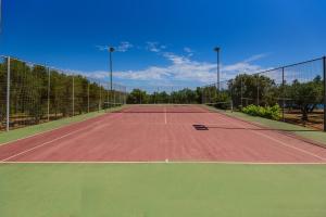 a tennis court with a net on top of it at Finisia House in Elia Laconias