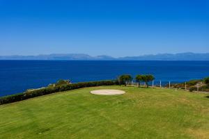 a putting green with a view of the ocean at Finisia House in Elia Laconias