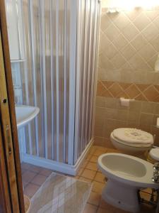 a bathroom with a toilet and a shower and a sink at Casa- Vacanza Giro' - C2A6PEU3OW in Aieta +26 photos