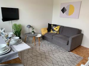 a living room with a couch and a table at FIVE Apartments in Tromsø