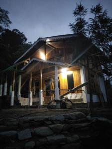 a house with lights on the front of it at night at Yuma Homestay in Mangpu