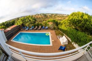 a swimming pool on top of a house at Mayla Surf House in Aljezur +16 photos