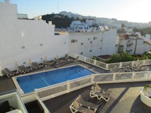 a swimming pool on the roof of a building at Bay View Apartment Albufeira in Albufeira