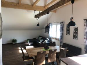 a living room with a table and a couch at Appartements Dürnle in Mühldorf