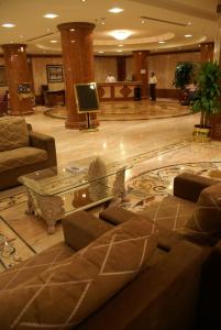 a lobby with a couch and a table and a tv at Saraya Harmony Hotel C in Al Madinah