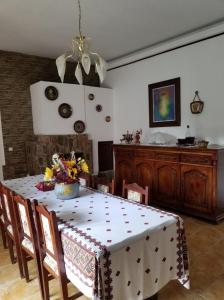 a dining room with a table with a white table cloth at Pensiunea Liana in Nemşa