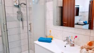a bathroom with a shower and a sink and a mirror at Appuntamento Al porto in Savona +44 photos