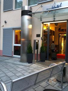 a bench sitting in front of a store at CineHotel Maroni in Zirndorf