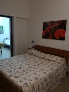 a bedroom with a bed with a comforter on it at Domo Silvia in La Maddalena +27 photos