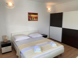 een slaapkamer met een bed met twee handdoeken erop bij Apartments Šime in Šibenik