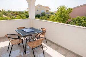a table and chairs on a balcony with a view at Apartment Vodice - Lovric in Vodice