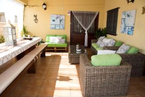 a living room with wicker chairs and couches at Villa Ca La Vicen in Deltebre