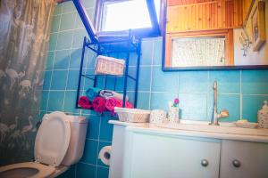 a blue tiled bathroom with a toilet and a sink at Estate Irene in Alexandroupoli +43 photos