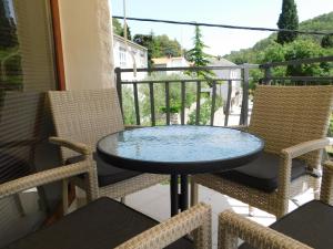 a table and two chairs on a balcony at Apartment Novigrad Holiday in Novigrad Dalmatia