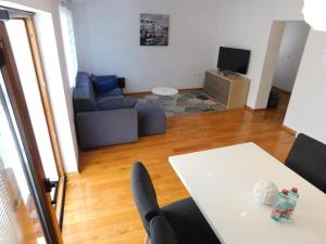 a living room with a table and a couch at Apartment Novigrad Holiday in Novigrad Dalmatia