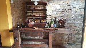a bar in a room with a stone wall at Rifugio della Pace Piano terra e Primo Piano in Sant' Isidoro +72 photos