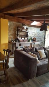 a living room with a couch and a brick wall at Rifugio della Pace Piano terra e Primo Piano in Sant' Isidoro +75 photos