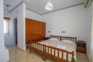 A bed or beds in a room at Irene Hotel Leros