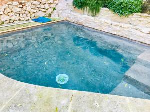 a swimming pool with a ball in the water at la bonbonniere - Townhouse Saint-Saturnin-lès-Apt in Saint-Saturnin-lès-Apt