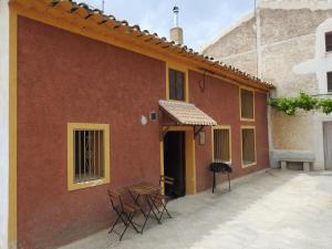 a group of chairs sitting outside of a building at CASA RURAL REVOLCADORES in Moratalla