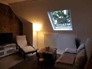 a living room with a couch and a window at Appartment Rheinaue in Duisburg
