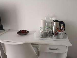 a white counter top with a coffee maker on it at Marko Airport Rooms in Velika Gorica +36 photos