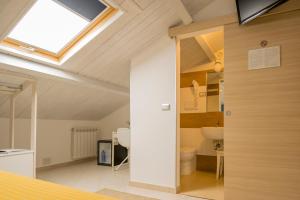 an attic bathroom with a skylight and a toilet at Civico 64 Bed & Breakfast in mansarda in Palmi +19 photos