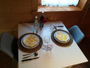 Studio im Blockhaus am Chiemsee في بيرناو آم شيمسي: طاولة بيضاء عليها طبقين من الطعام
