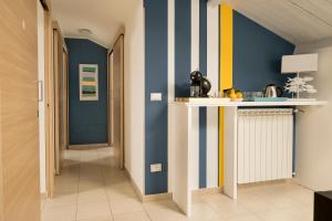 a hallway with blue and yellow stripes on the wall at Civico 64 Bed & Breakfast in mansarda in Palmi